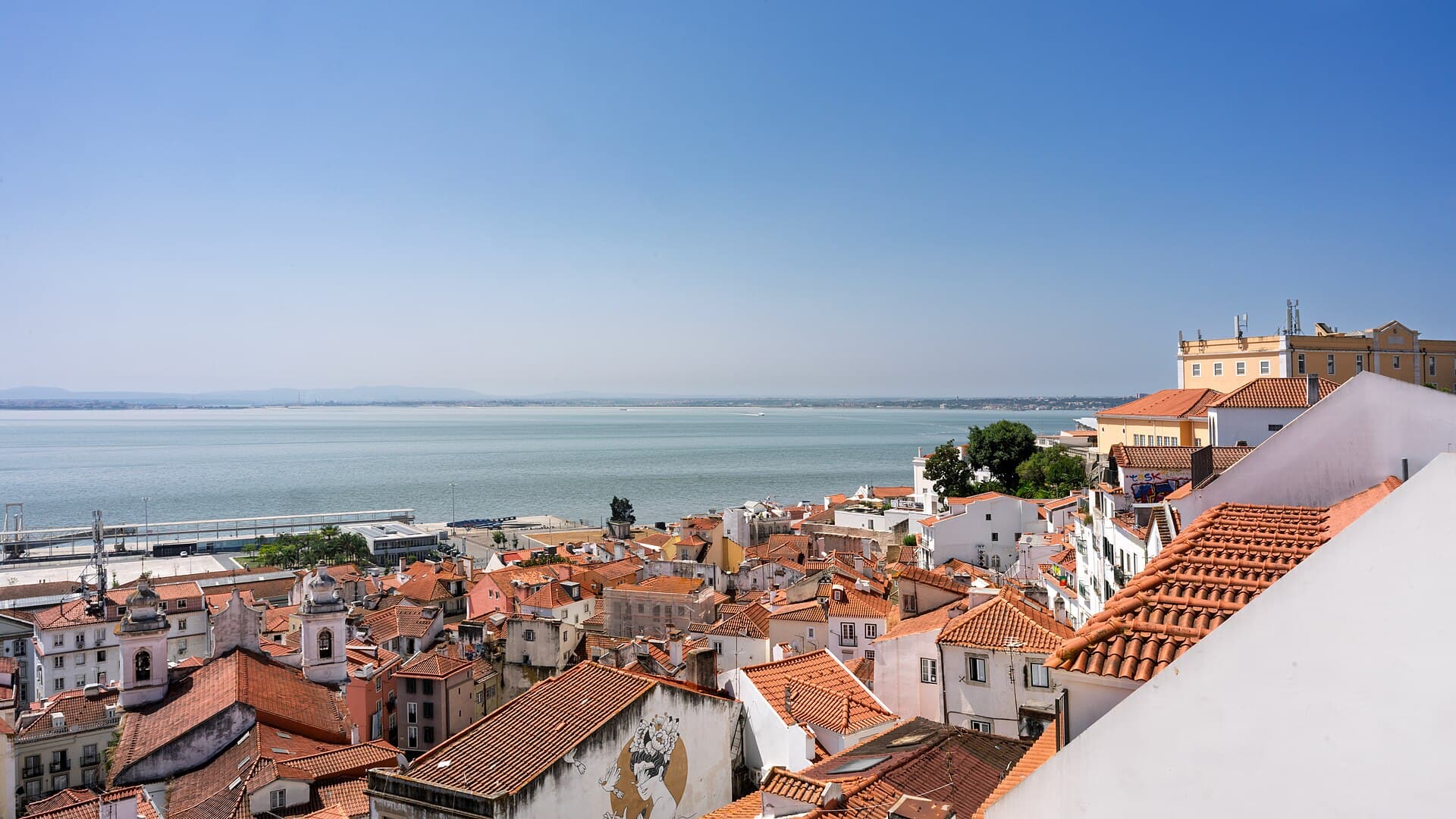 Red-tiled rooftops of the Alfama district above the Tagus River